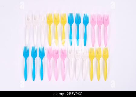 Disposable plastic forks on white background Stock Photo