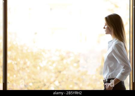 Side view lost in thoughts young female entrepreneur. Stock Photo