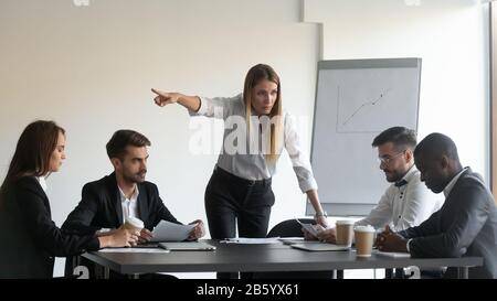 Angry female team leader director manager asking employee to leave. Stock Photo
