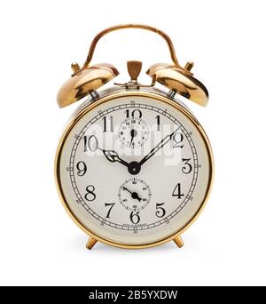 Old fashioned mechanical alarm clock with bells on top with hands at eight minutes past ten Stock Photo