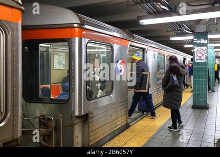 People boarding a SEPTA Broad Street Line subway train at Tasker Morris in South Philly, Philadelphia, PA. February 29, 2020. Stock Photo