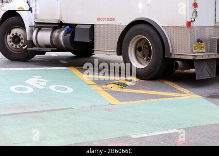 A sneckdown with rubber bumper used on a road to calm traffic; to deter corner cutting and high speed left turns in an intersection. Stock Photo