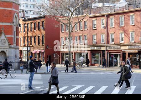 People and buildings on the corner of West 10th St and Sixth Ave; Jefferson Market in Manhattan, New York, NY. Stock Photo