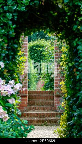 steps leading through doorway into garden Stock Photo