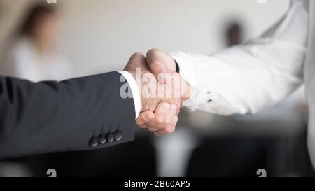 Two masculine businessmen hands shaking each other. Stock Photo