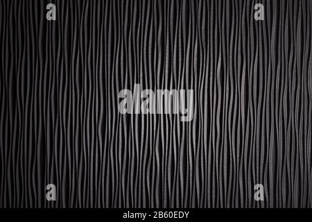Wooden black undulating surface texture. Close up Stock Photo