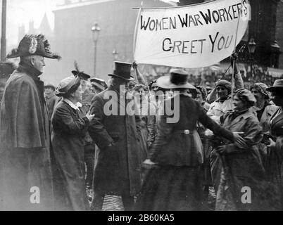DAVID LLOYD GEORGE (1863-1945) as PM meeting women munitions workers in Manchester in September 1918. Leading suffragettes Flora Drummond at left and Phyllis Ayrton in wide brimmed hat make their case to the PM.