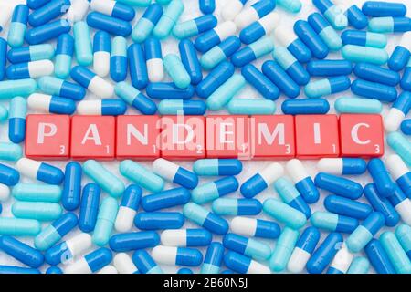 Drug capsules / pills & Letter tiles with word PANDEMIC. For 2020 Coronavirus pandemic, COVID-19, CV19, Wuhan virus, medication, SARS, MERS, new virus Stock Photo