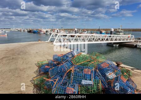 Crab pot fishing gear with yellow coiled polypropylene rope and buoys  waiting to be launched into the ocean to catch seafood Stock Photo - Alamy
