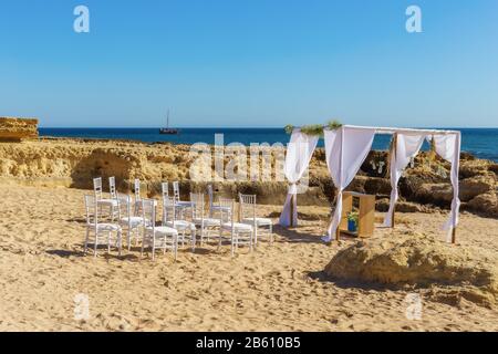 Beautiful Decorated Romantic Wedding Table on Sandy Tropical Caribbean Beach at Sunset Stock Photo