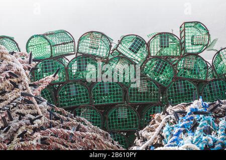 A stack of traps for catching fish and shellfish. On the quay of the sea. Stock Photo