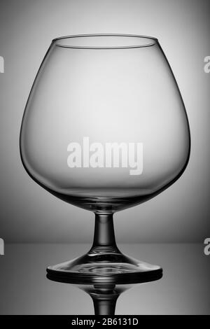 Empty glass snifter on the leg. For alcoholic beverages. Stock Photo