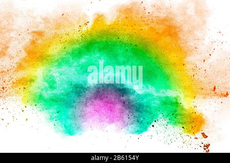 Abstract multi color powder explosion on white background.Freeze motion of dust particles splash. Stock Photo