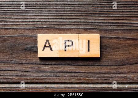 API word written on wood block. API text on wooden table for your desing, Top view concept. Stock Photo