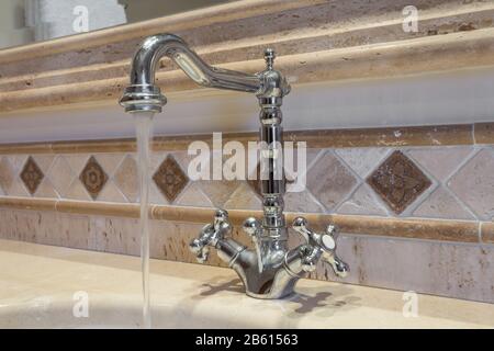 Vintage faucet, in the bathroom with the water. Stock Photo