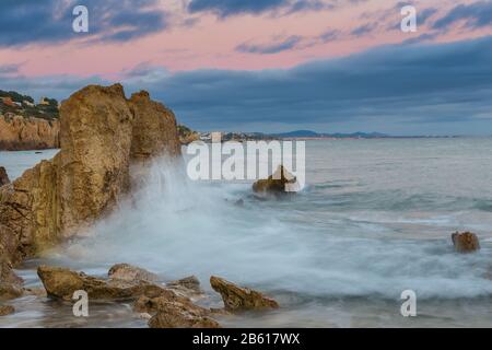 Waves crashing against the rocks. Albufeira beach Riffes. Stock Photo