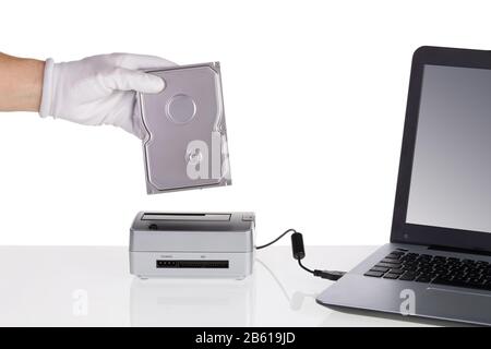 Installing hard disk and read in docking station. Connecting to a computer. Stock Photo