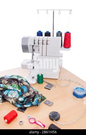 Overlock sewing machine on the table. Sewing Accessories. Stock Photo