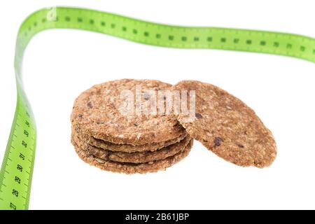Oatmeal cookies on a background of a meter to measure. Diet for weight loss. Stock Photo