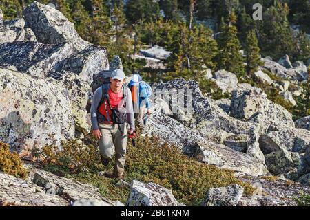 Father and son walking in the mountains Stock Photo