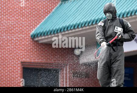 (200309) -- SEOUL, March 9, 2020 (Xinhua) -- A soldier disinfects an apartment building where mass coronavirus infections occurred in Daegu, South Korea, March 9, 2020. South Korea confirmed 96 more cases of the COVID-19 on Monday, raising the total number of infections to 7,478. (NEWSIS/Handout via Xinhua) Stock Photo