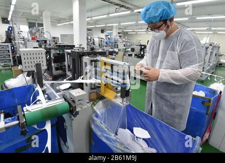 (200309) -- SEOUL, March 9, 2020 (Xinhua) -- A staff member checks face masks at a mask producing company in Yongin, South Korea, March 9, 2020. South Korea confirmed 96 more cases of the COVID-19 on Monday, raising the total number of infections to 7,478. (NEWSIS/Handout via Xinhua) Stock Photo