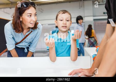 Child boy explain and gesticulate to his mother, education concept Stock Photo