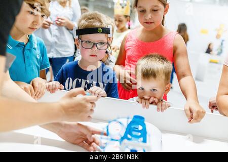 ULTRA MALL, UFA, RUSSIA, 21 AUGUST, 2017: children study and look at modern robots at an open exhibition in the shopping center ULTRA Stock Photo