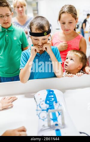 ULTRA MALL, UFA, RUSSIA, 21 AUGUST, 2017: Child with the sensor device on the head doing mental and brain experiment Stock Photo