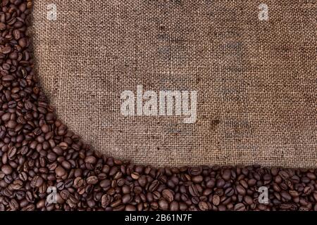 Frame of coffee beans on vintage sackcloth. Stock Photo