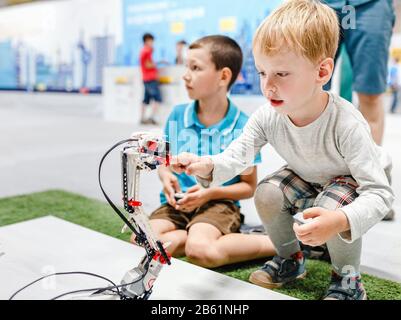 ULTRA MALL, UFA, RUSSIA, 21 AUGUST, 2017: Kid boy playing with interactive robot toy at the exhibition Stock Photo