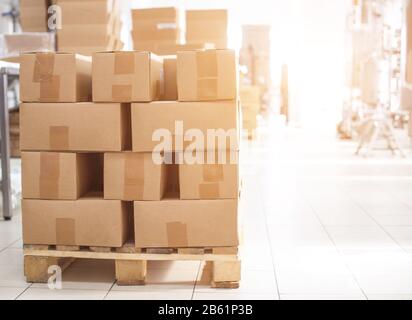 Boxes of finished products of pasta and cereals are in the production hall against the background of the equipment. Food industry, copy space Stock Photo