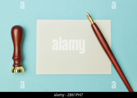 Antique wooden pen to ink and paper for writing. Stock Photo