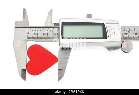 Vernier caliper measures the heart. On Valentine's Day. Stock Photo