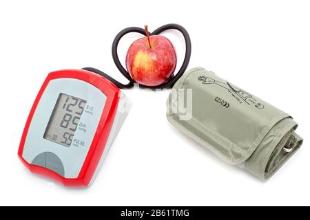 The instrument for measuring the pressure hose in the shape of heart. Apple is a symbol of health. Stock Photo