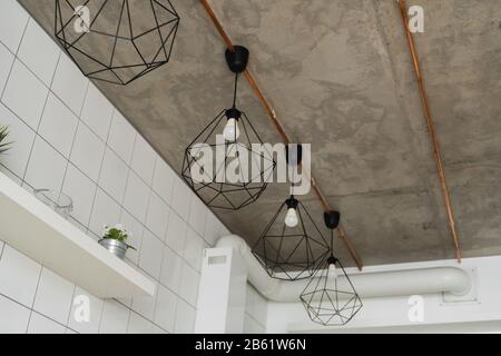 Lighting on a modern kitchen in comfortable apartment. Vintage luxury interior lighting lamp as a home decor. Stock Photo