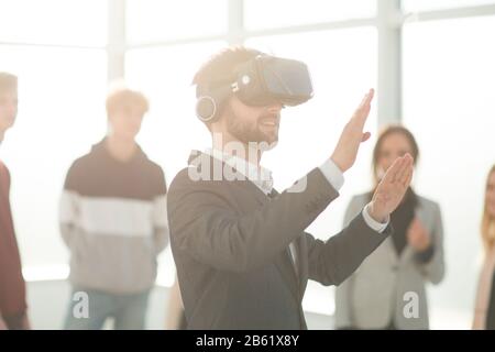 background image of a young man in a virtual reality helmet Stock Photo