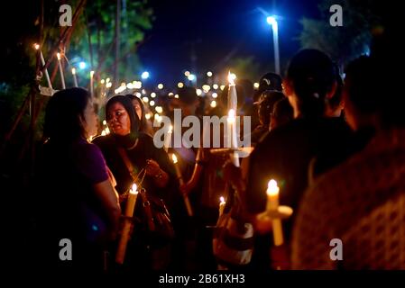 Pilgrims take a pause while participating in Good Friday street procession in Larantuka, Flores Island, Indonesia. Stock Photo