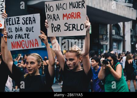 Poster in the 8M protest that says 'Happy is going to be the day that no woman is missing' and 'I was not born womanto die for being it' Stock Photo