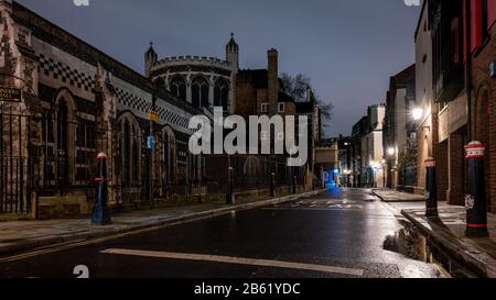 London, England, UK - February 25, 2020: Traditional houses and offices line the historic Cloth Fair street beside the Priory Church of St Bartholomew Stock Photo