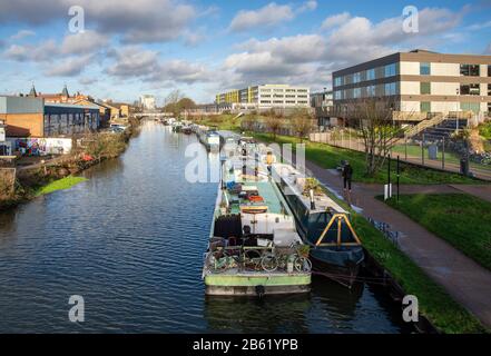 London, England, UK - January 17, 2020: Houseboats are moored in the River Lea Navigation beside the regenerated Hackney Wick neighbourhood of East Lo Stock Photo