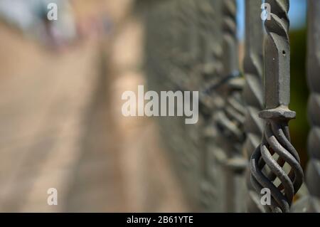 detail of an old and rusty baluster of a railing with the rest of it out of focus Stock Photo
