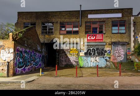 London, England, UK - January 2, 2020: Light industrial buildings stand derelict and abandoned during regeneration of the Fish Island neighbourhood of Stock Photo