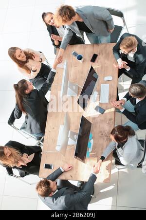 top view. happy employees shaking hands during a meeting Stock Photo
