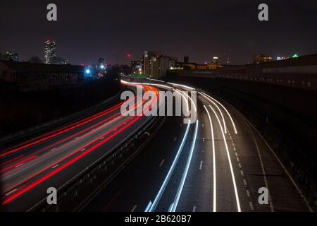 London, England, UK - December 12, 2019: Light trails of fast moving traffic flow along the East Cross Route motorway in the East End of London. Stock Photo