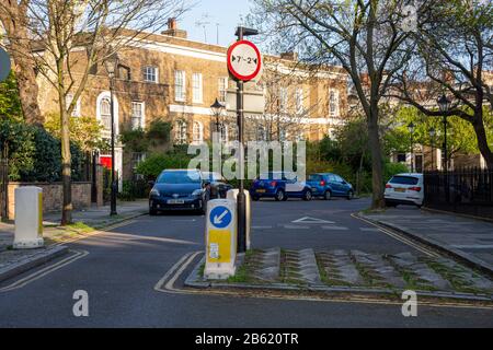 London, England, UK - April 11, 2019: An example of a traffic calming and filtering feature, restricting wide vehicles from a residential area, while Stock Photo