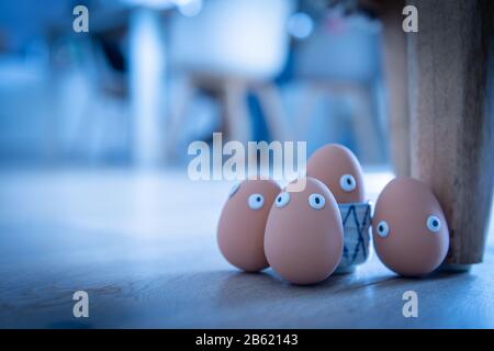A group of Easter eggs with funny eyes is hidden early in the morning, children have to look for them. Happy Easter concept, Easter theme, background, Stock Photo