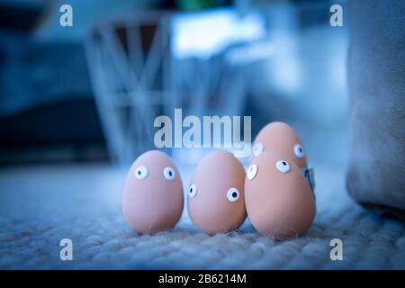 A group of Easter eggs with funny eyes is hidden early in the morning, children have to look for them. Happy Easter concept, Easter theme, background, Stock Photo