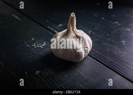 Bulbs of garlic on a dark background. Low key lighting Stock Photo