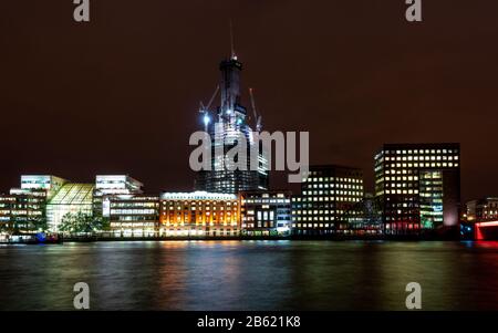 London, England, UK - October 13, 2010: The Shard skyscraper is lit at night during construction at London Bridge on the Thames riverside. Stock Photo